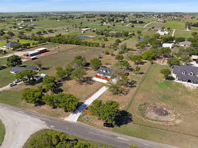 birds eye view of property with a rural view