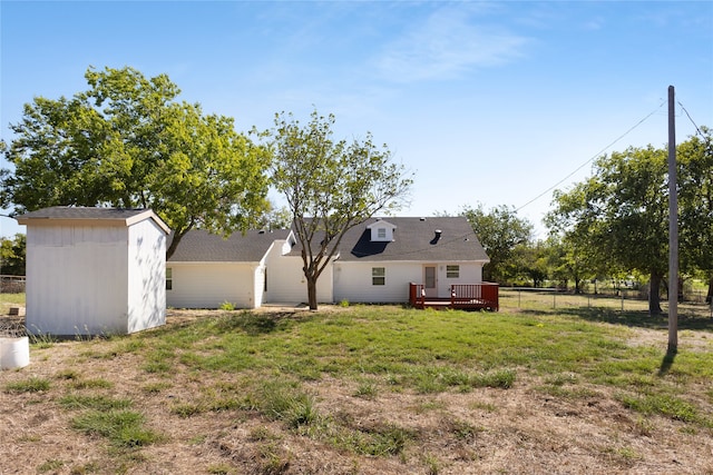 view of yard featuring a wooden deck and a shed