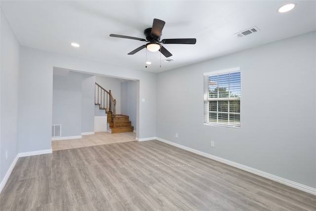 kitchen featuring ceiling fan, light stone counters, sink, gray cabinetry, and stainless steel appliances