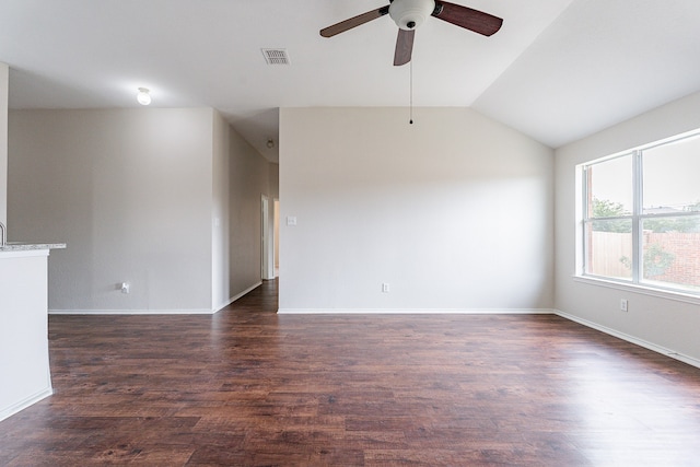 empty room with ceiling fan, dark hardwood / wood-style flooring, and lofted ceiling