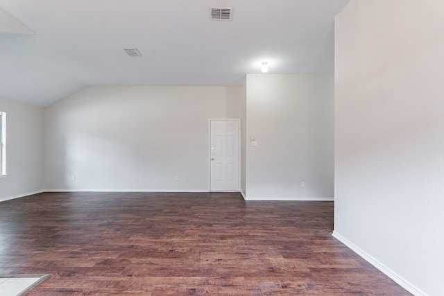 unfurnished room with hardwood / wood-style floors and lofted ceiling