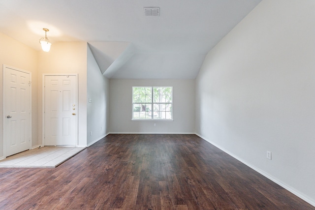 spare room with lofted ceiling and hardwood / wood-style flooring