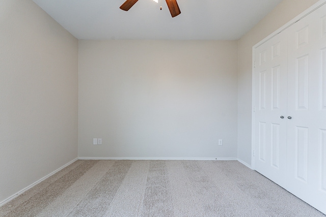 unfurnished bedroom with ceiling fan, a closet, and carpet floors