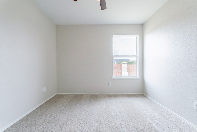 unfurnished room with ceiling fan and carpet floors