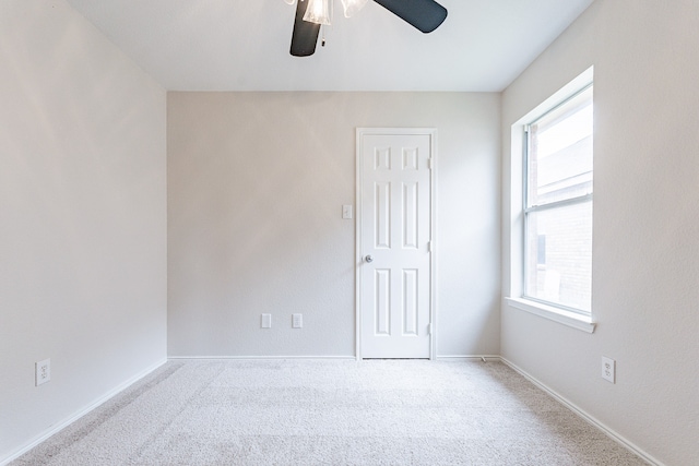 empty room with carpet and ceiling fan