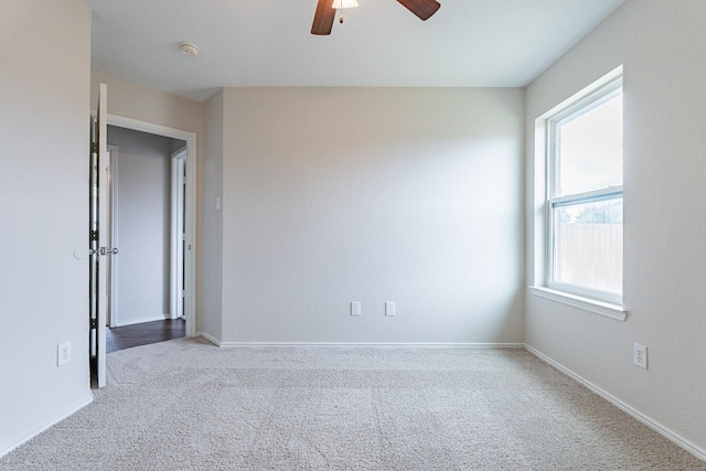 empty room featuring carpet flooring and ceiling fan