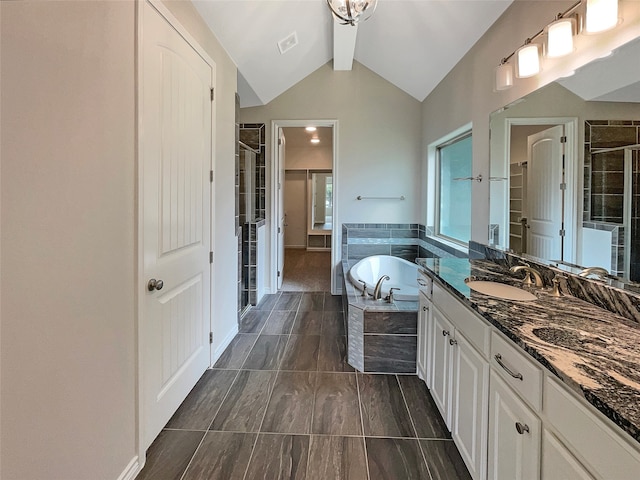 bathroom featuring shower with separate bathtub, lofted ceiling with beams, vanity, and tile patterned flooring