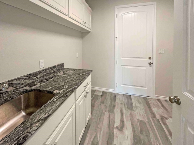 interior space with sink and hardwood / wood-style floors