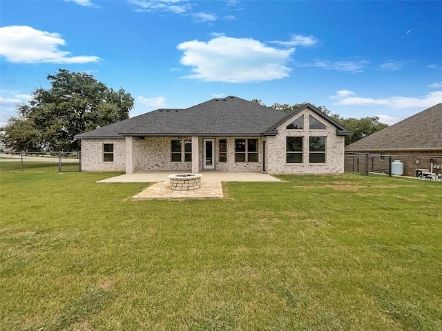 back of house featuring a patio and a yard