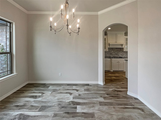 unfurnished room featuring crown molding, tile patterned flooring, and an inviting chandelier