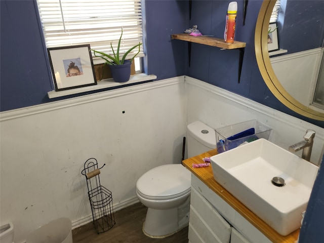 bathroom featuring vanity, toilet, and hardwood / wood-style floors