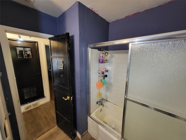 bathroom featuring shower / bath combination with glass door and wood-type flooring