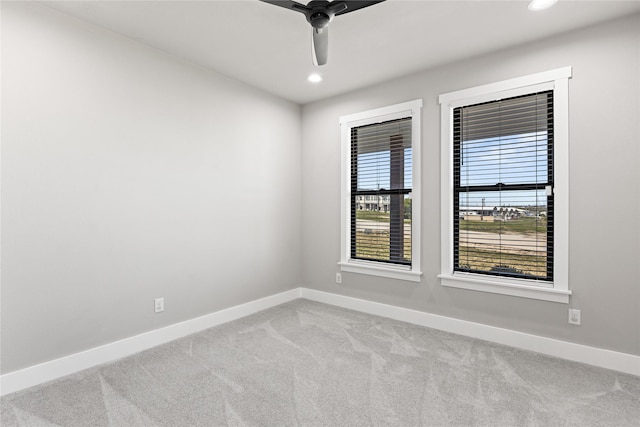 carpeted empty room featuring ceiling fan