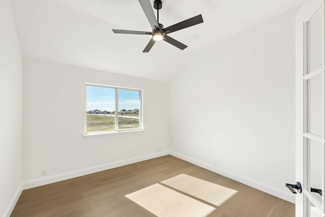 spare room featuring hardwood / wood-style flooring, ceiling fan, and lofted ceiling