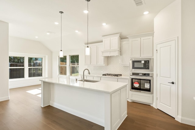 kitchen featuring white cabinetry, sink, stainless steel appliances, an island with sink, and decorative light fixtures