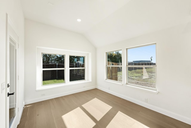 unfurnished sunroom featuring a healthy amount of sunlight and vaulted ceiling