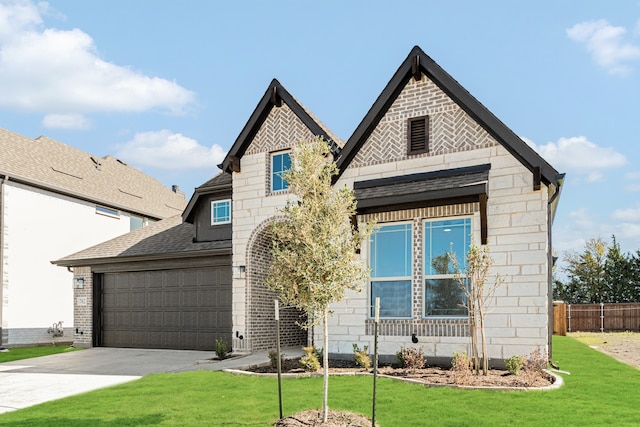 view of front of home featuring a garage and a front yard