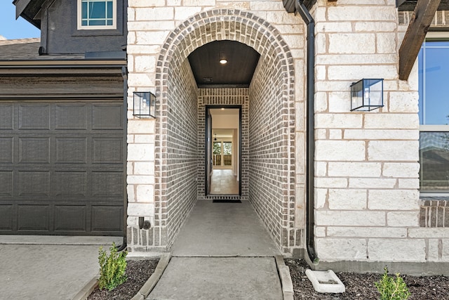 view of exterior entry featuring a garage