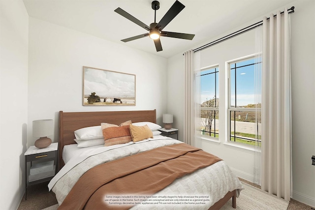 bedroom with multiple windows, carpet, and ceiling fan