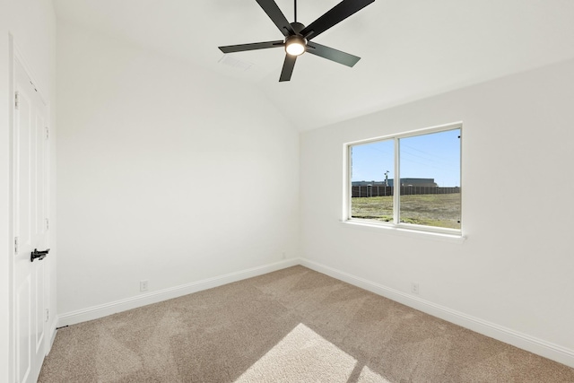 carpeted spare room featuring ceiling fan and lofted ceiling