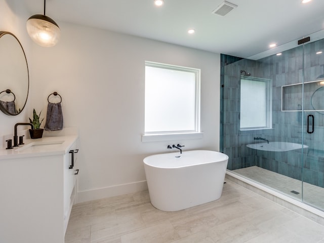 bathroom with vanity and plus walk in shower