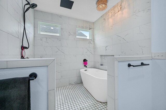 bathroom with tile walls, a tile shower, and tile patterned flooring