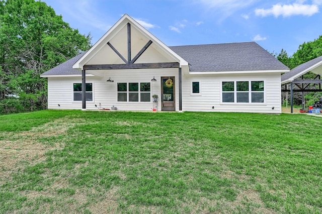 rear view of house with a yard