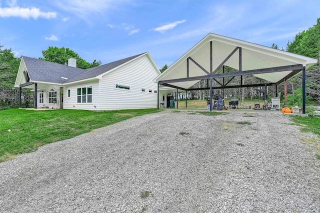 exterior space featuring a carport and a lawn