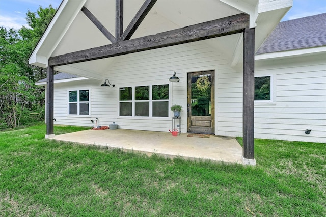 back of house featuring a lawn and a patio