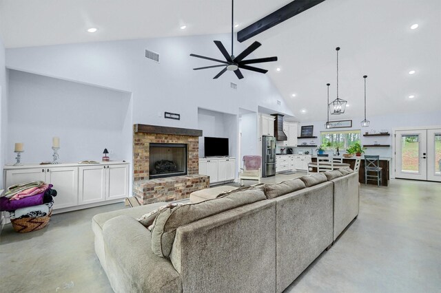 living room with ceiling fan, french doors, a brick fireplace, high vaulted ceiling, and beamed ceiling