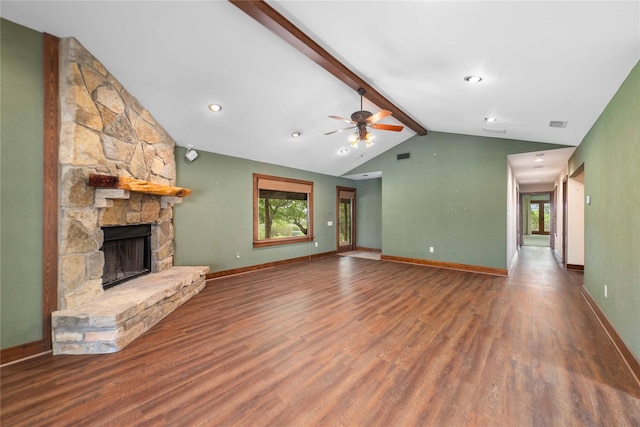 unfurnished living room with ceiling fan, a fireplace, hardwood / wood-style flooring, and vaulted ceiling with beams