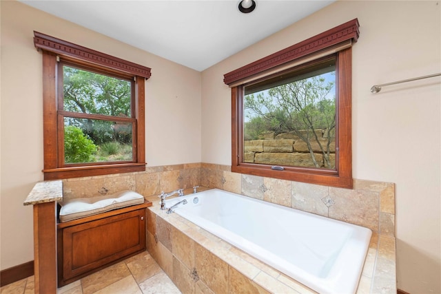 bathroom featuring tiled bath and tile patterned flooring