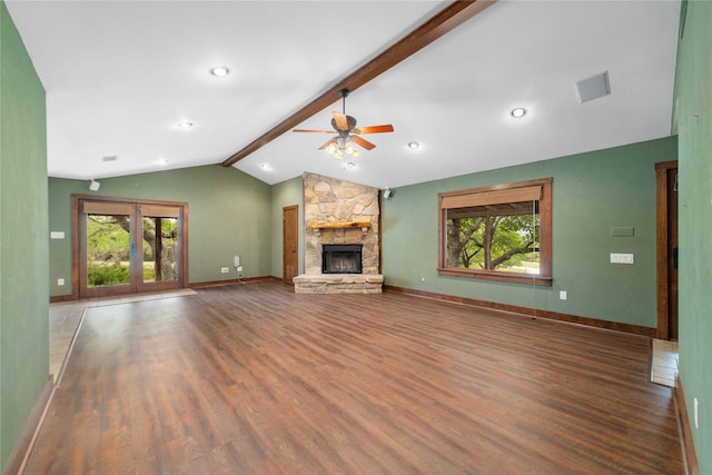 unfurnished living room with ceiling fan, a fireplace, plenty of natural light, and hardwood / wood-style flooring