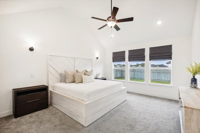 carpeted bedroom featuring ceiling fan and high vaulted ceiling