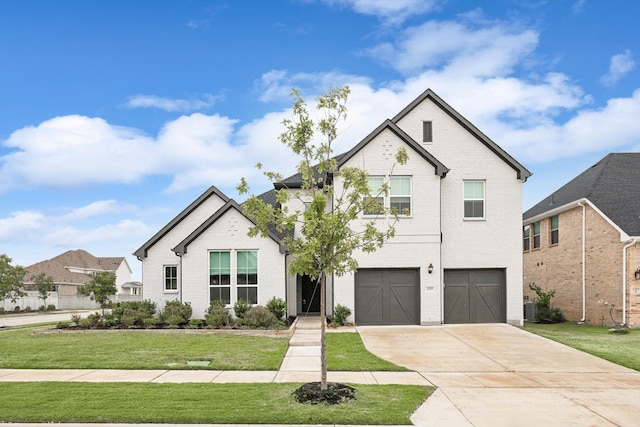 view of front of property with a front yard and a garage