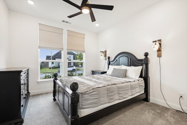 bedroom with ceiling fan and light colored carpet