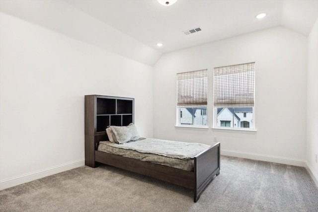 carpeted bedroom with vaulted ceiling