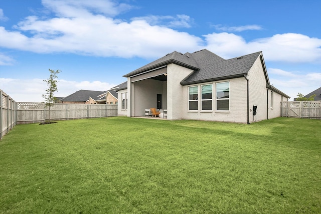 back of property with a patio and a yard