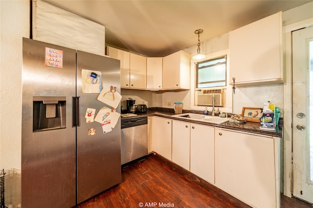 kitchen featuring sink, decorative light fixtures, white cabinetry, appliances with stainless steel finishes, and dark hardwood / wood-style floors