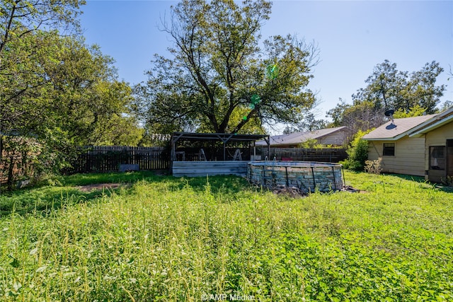 view of yard with a fenced in pool