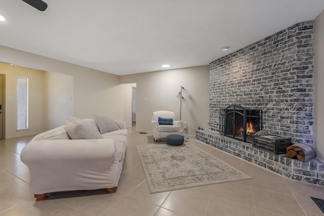 living room featuring a fireplace and light tile patterned floors