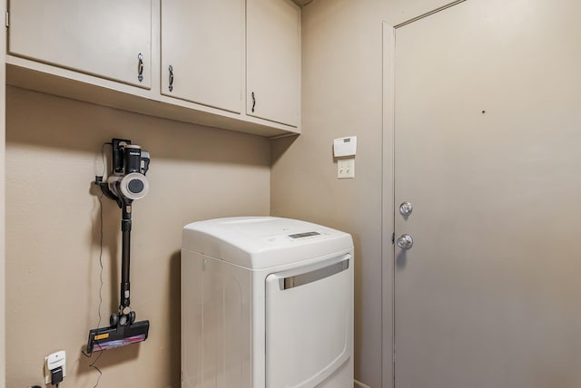 laundry area featuring cabinets