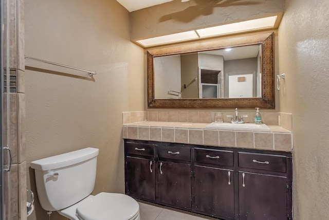 bathroom featuring tile patterned flooring, vanity, and toilet