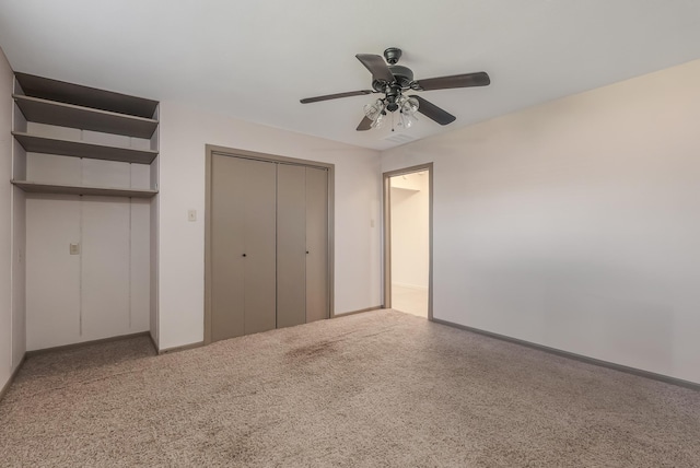 unfurnished bedroom with carpet, a closet, and ceiling fan