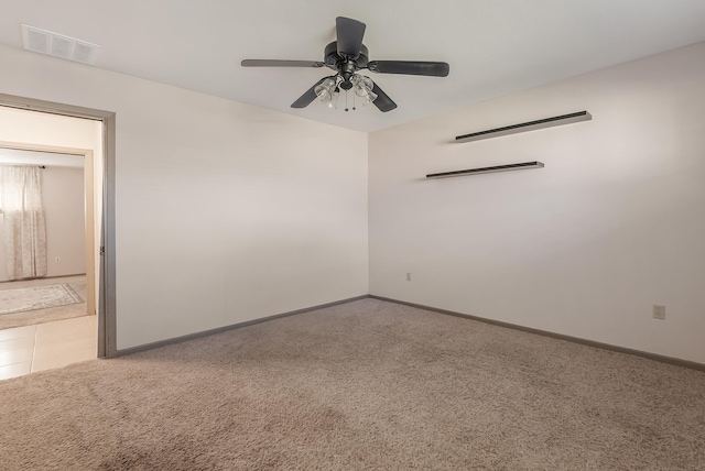 carpeted spare room with ceiling fan