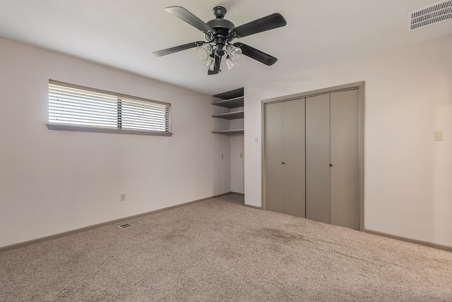 unfurnished bedroom with carpet flooring, a closet, and ceiling fan