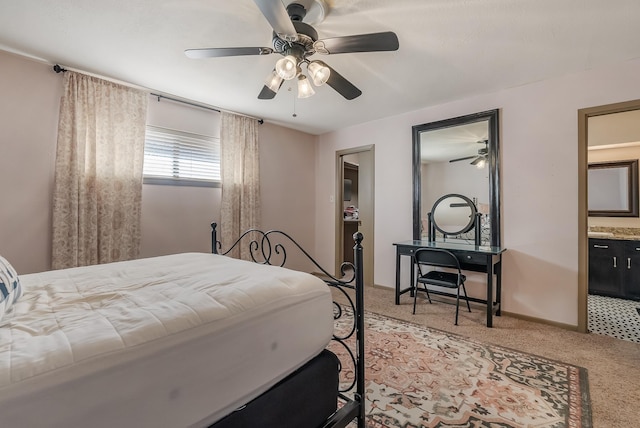 carpeted bedroom with connected bathroom and ceiling fan