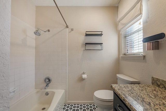 full bathroom featuring toilet, vanity, and tiled shower / bath combo