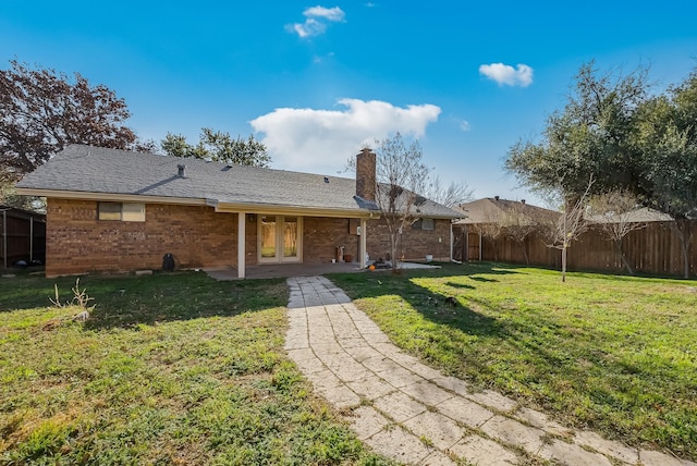 rear view of house with a yard