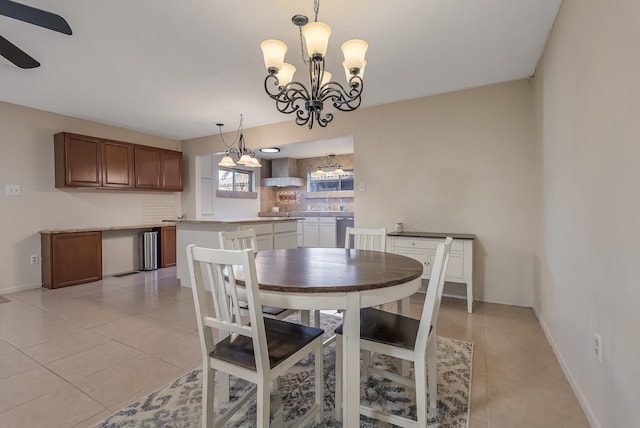 dining space with ceiling fan with notable chandelier and light tile patterned floors